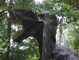 An animatronic T-Rex hides in the woods at the Combe Martin Wildlife & Dinosaur Park
